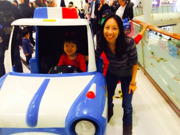 Roxy riding a police car at Tsing Yi Mall