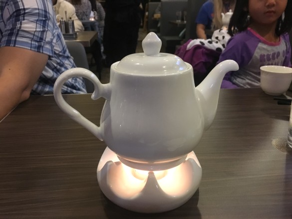 Chrysanthemum Tea served in a pot with a candle light